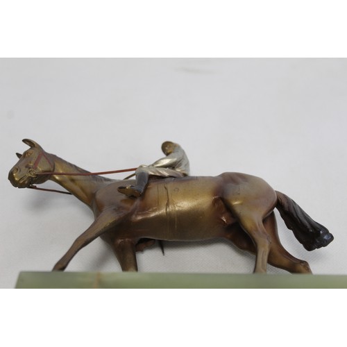 301 - Early 20th century Austrian cold painted bronze figure of a racehorse and jockey on stepped green on... 