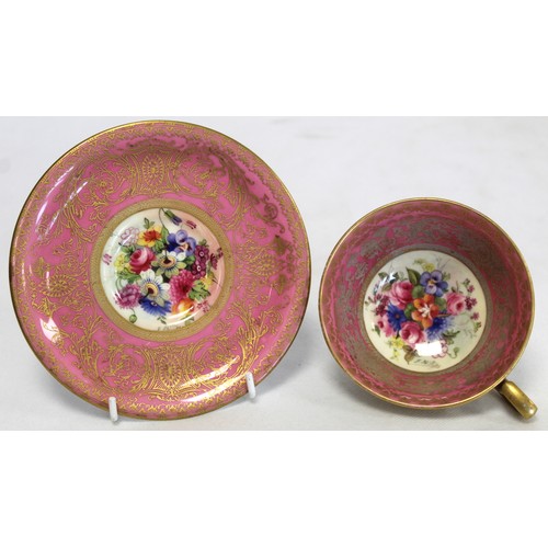 304 - Royal Worcester cabinet cup and saucer with polychrome painted floral panels surrounded by pink and ... 