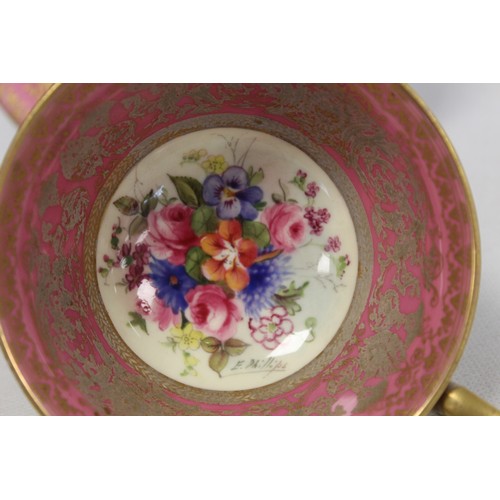 304 - Royal Worcester cabinet cup and saucer with polychrome painted floral panels surrounded by pink and ... 