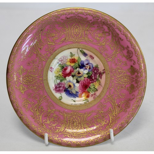 304 - Royal Worcester cabinet cup and saucer with polychrome painted floral panels surrounded by pink and ... 