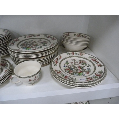 102 - Large quantity of Johnson Bros Indian Tree dinnerwares, also an Indian tablecloth (three shelves).