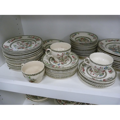 102 - Large quantity of Johnson Bros Indian Tree dinnerwares, also an Indian tablecloth (three shelves).