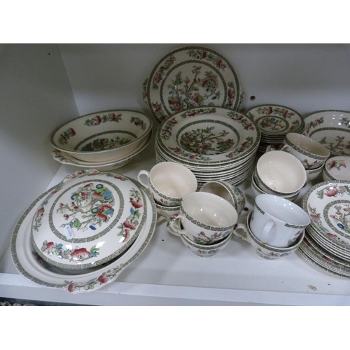 102 - Large quantity of Johnson Bros Indian Tree dinnerwares, also an Indian tablecloth (three shelves).