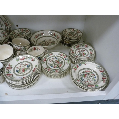 102 - Large quantity of Johnson Bros Indian Tree dinnerwares, also an Indian tablecloth (three shelves).