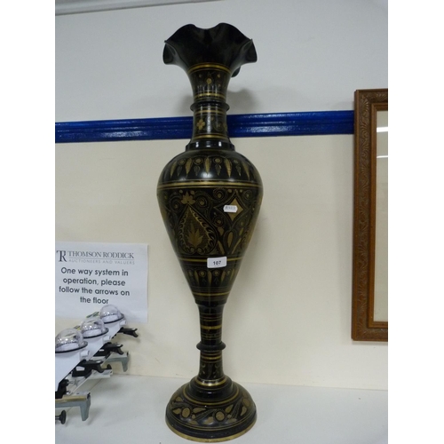107 - Large middle eastern-style metal vase decorated with panels on a black ground.