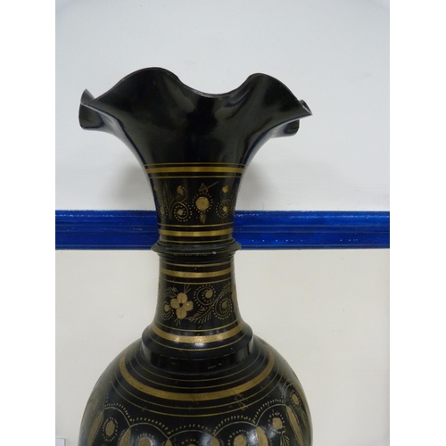 107 - Large middle eastern-style metal vase decorated with panels on a black ground.