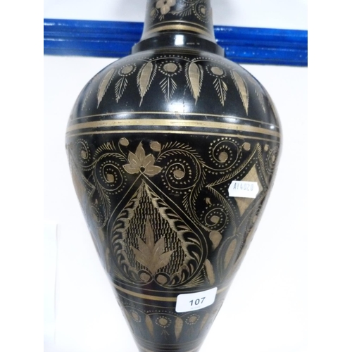 107 - Large middle eastern-style metal vase decorated with panels on a black ground.