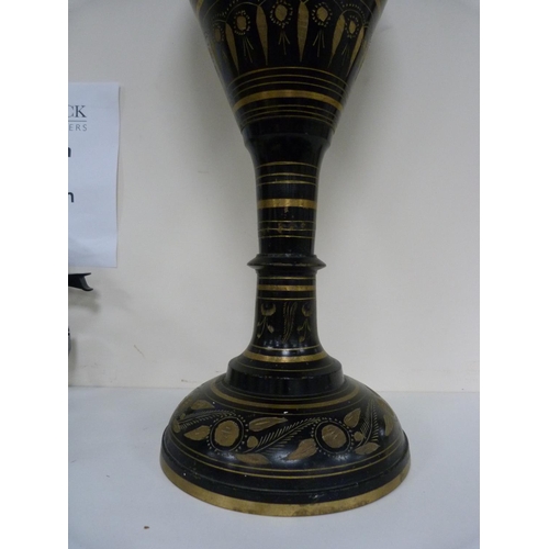 107 - Large middle eastern-style metal vase decorated with panels on a black ground.