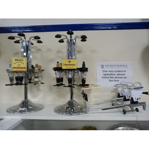 111 - Three optics, including Bells Scotch Whisky and another labelled for Hennessey Cognac.