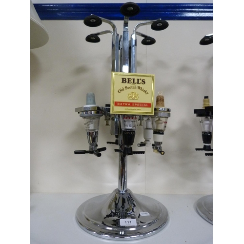 111 - Three optics, including Bells Scotch Whisky and another labelled for Hennessey Cognac.