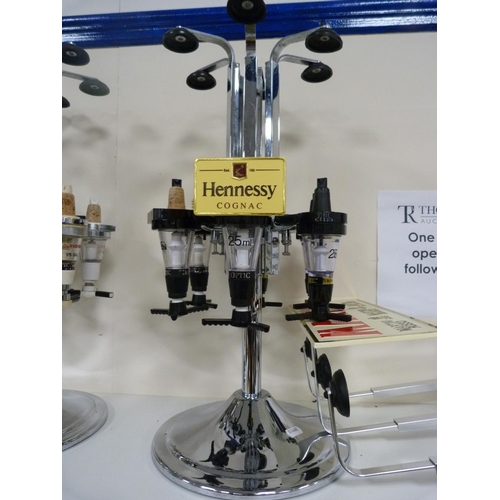 111 - Three optics, including Bells Scotch Whisky and another labelled for Hennessey Cognac.