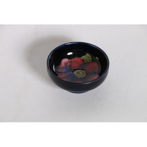 37 - Moorcroft blue ground dish with label to reverse, 8cm diameter.