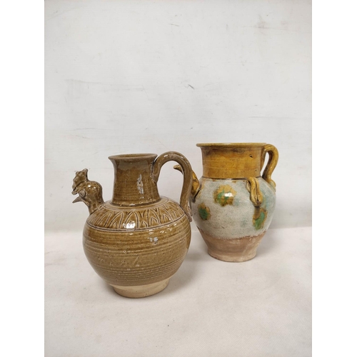 144 - Early Chinese, possibly Tang dynasty, pottery ewer, part yellow glazed, 18cm high and a brown glazed... 