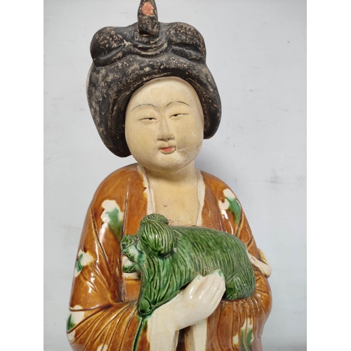 151 - Large Chinese sancai pottery figure of a Tang dynasty court lady with lapdog, 64cm high.