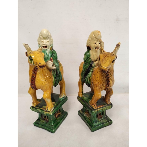 156 - Mirror pair of Chinese pottery statues in the sancai palette depicting Shoulao astride his deer, 36c... 