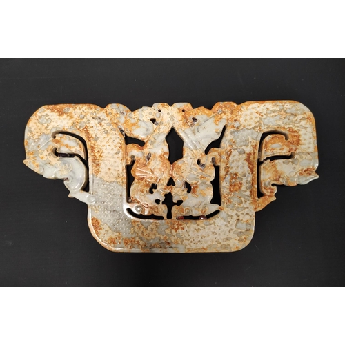 187 - Large Chinese jade plaque in archaic style, depicting stylised dragon heads, 25cm wide.