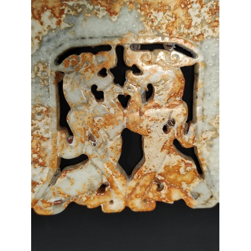 187 - Large Chinese jade plaque in archaic style, depicting stylised dragon heads, 25cm wide.