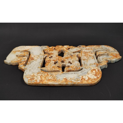 187 - Large Chinese jade plaque in archaic style, depicting stylised dragon heads, 25cm wide.