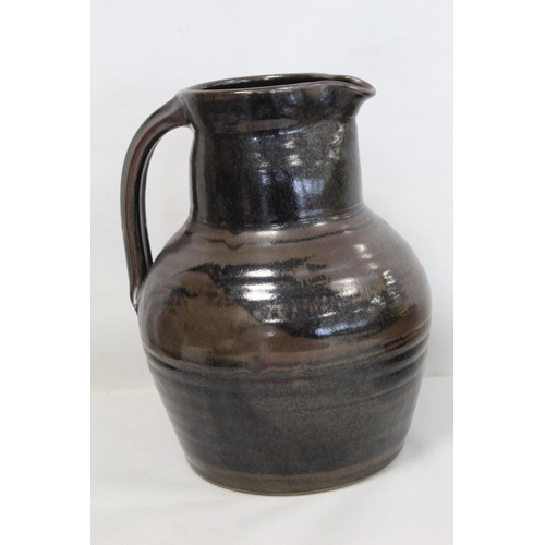 316 - Harry and May Davis Crowan Cornish studio pottery jug of baluster form with tenmoku glaze, with impr... 