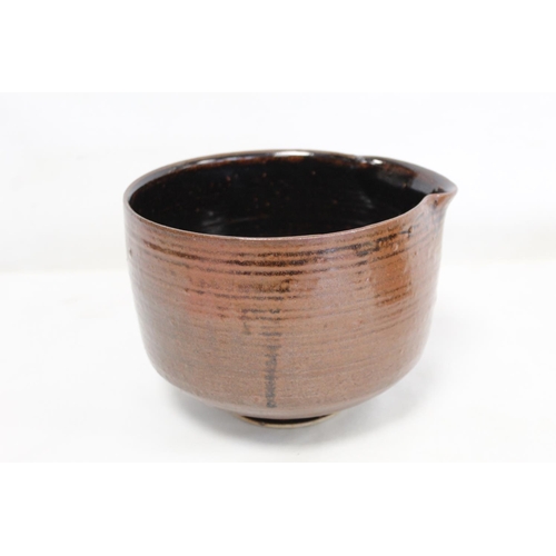 321 - 1970's studio pottery deep bowl of circular footed form with lip and tenmoku glaze, incised mark J.T... 