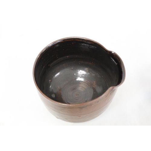 321 - 1970's studio pottery deep bowl of circular footed form with lip and tenmoku glaze, incised mark J.T... 