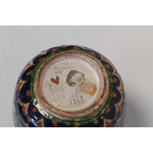 326 - Small Iznik pottery vase of ovoid form decorated in blues, green and ochre with stylised flowerheads... 