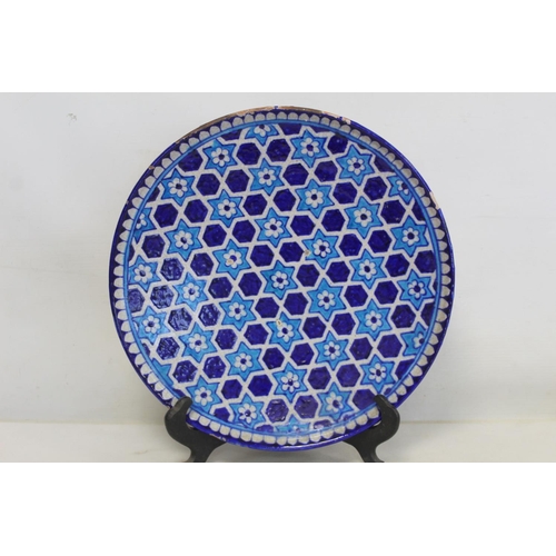 327 - Iznik pottery circular plate with flowerhead star lattice decoration in turquoise and royal blue, 32... 