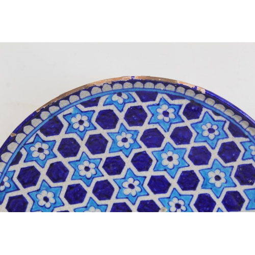 327 - Iznik pottery circular plate with flowerhead star lattice decoration in turquoise and royal blue, 32... 