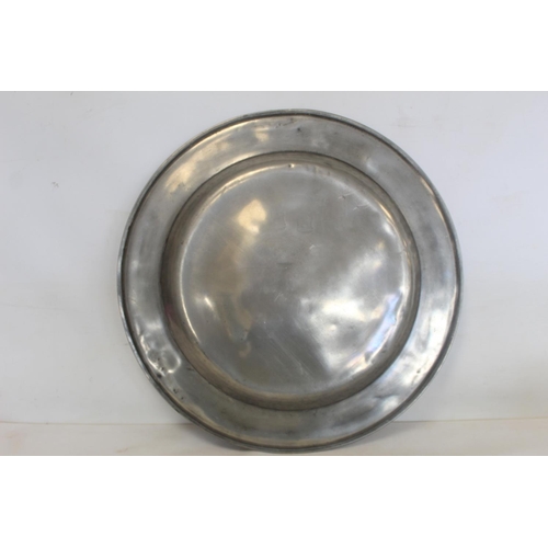 335 - Two large circular pewter chargers, each 42cm diam., with stamped initials M.R.D. (one split); a pew... 