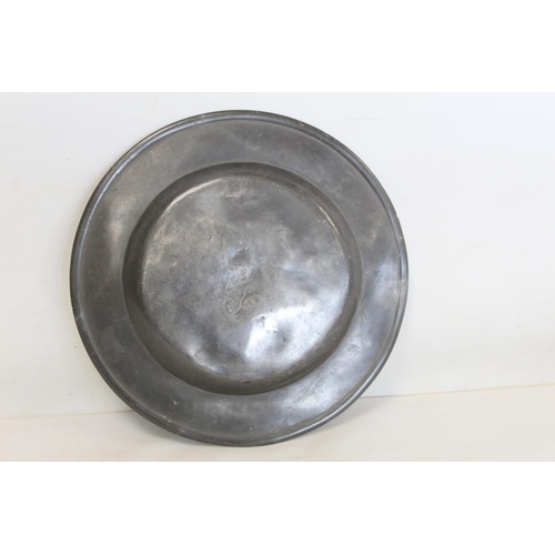 335 - Two large circular pewter chargers, each 42cm diam., with stamped initials M.R.D. (one split); a pew... 