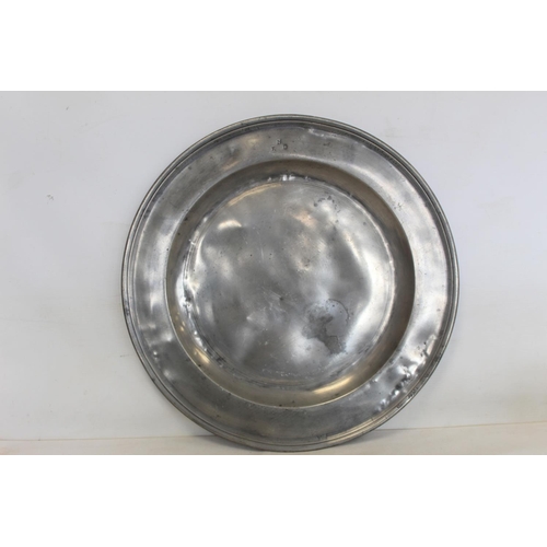 335 - Two large circular pewter chargers, each 42cm diam., with stamped initials M.R.D. (one split); a pew... 