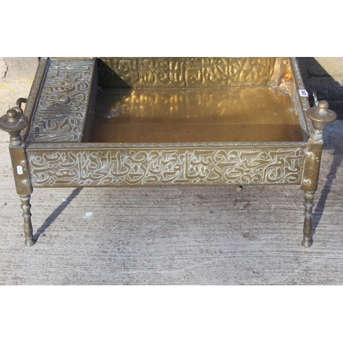 347 - Islamic Cairoware brass trough of rectangular twin handled form with two fixed handles and four turn... 