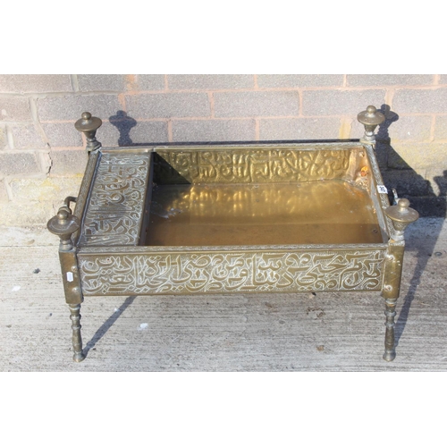 347 - Islamic Cairoware brass trough of rectangular twin handled form with two fixed handles and four turn... 