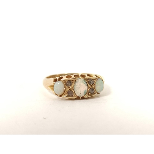 103 - 18ct gold ring with three opals and diamond points, 1914. Size 'P'.