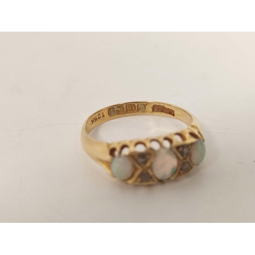 103 - 18ct gold ring with three opals and diamond points, 1914. Size 'P'.