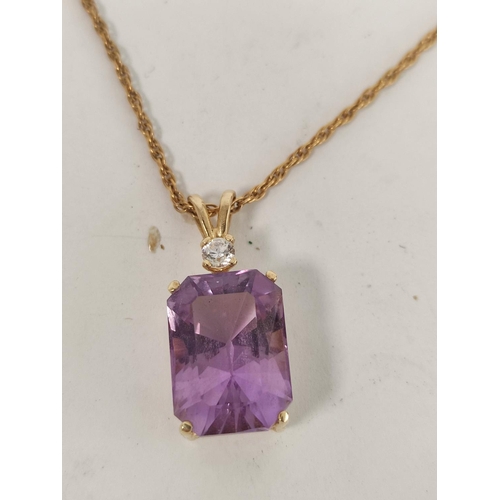 105 - Gold pendant with rectangular amethyst and diamond, probably '14'.