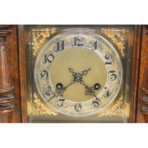 116 - Junghams mantel clock with silvered and ivory dial, in walnut and rosewood case with turned columns.... 