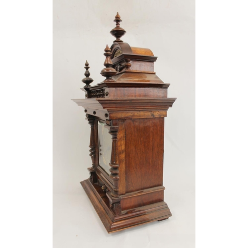 116 - Junghams mantel clock with silvered and ivory dial, in walnut and rosewood case with turned columns.... 