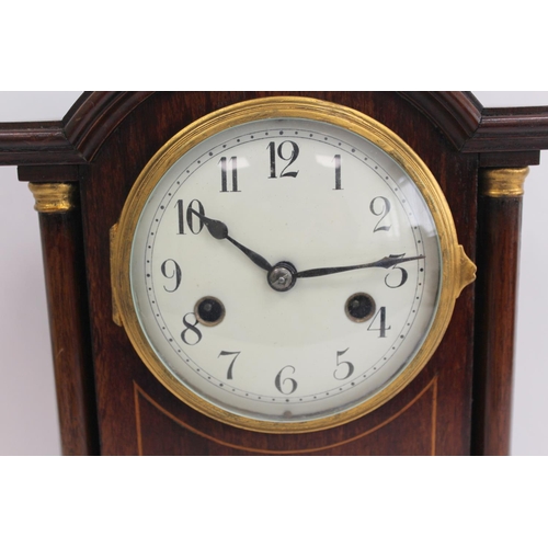 118 - Edwardian period mantle clock in inlaid rosewood case with break arch. 32cm. 