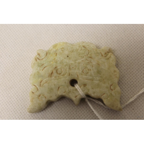 181 - Three Chinese archaic and archaised jade carvings to include a belt hook with dragon head carving, a... 