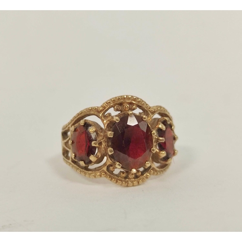 79 - Garnet three stone ring in 9ct gold. Size 'O'.