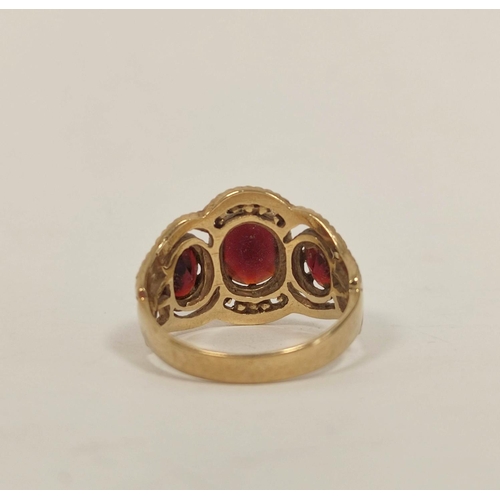 79 - Garnet three stone ring in 9ct gold. Size 'O'.