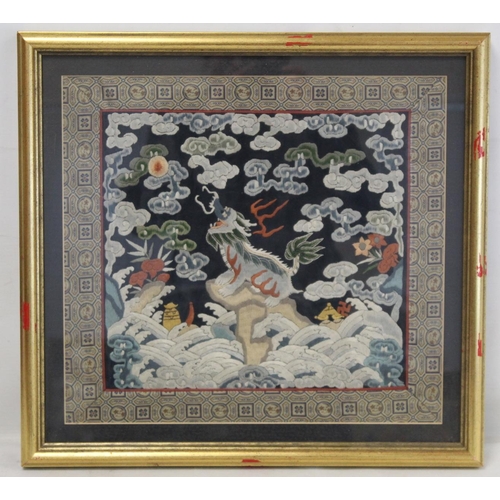 452 - 19th or early 20th century Chinese embroidered silk panel depicting a Dog of Fo on rock amongst foam... 