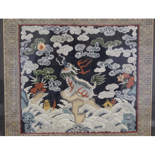 452 - 19th or early 20th century Chinese embroidered silk panel depicting a Dog of Fo on rock amongst foam... 