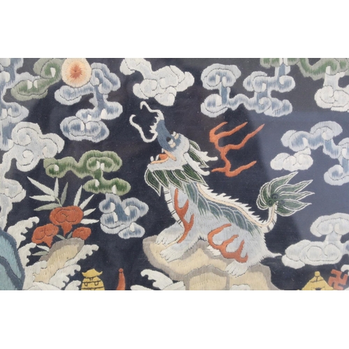 452 - 19th or early 20th century Chinese embroidered silk panel depicting a Dog of Fo on rock amongst foam... 