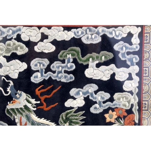 452 - 19th or early 20th century Chinese embroidered silk panel depicting a Dog of Fo on rock amongst foam... 