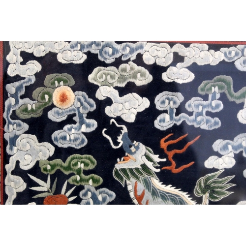 452 - 19th or early 20th century Chinese embroidered silk panel depicting a Dog of Fo on rock amongst foam... 