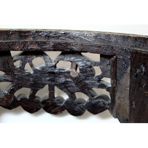 271 - Eastern pierced and carved hardwood footstool of oval form with four scroll feet and foliate decorat... 