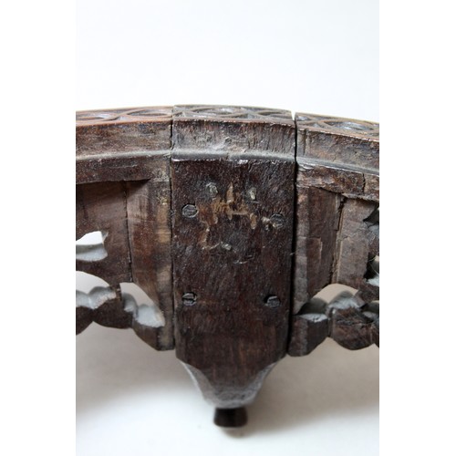 271 - Eastern pierced and carved hardwood footstool of oval form with four scroll feet and foliate decorat... 