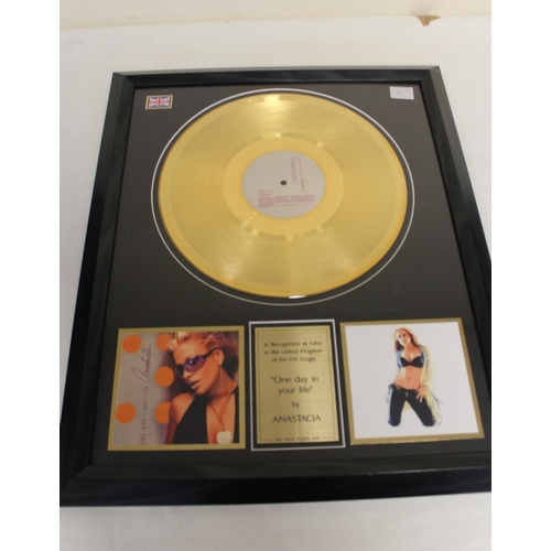 598 - Two framed music memorabilia of Anastasia, one gold plated vinyl record of the song 'One Day In Your... 